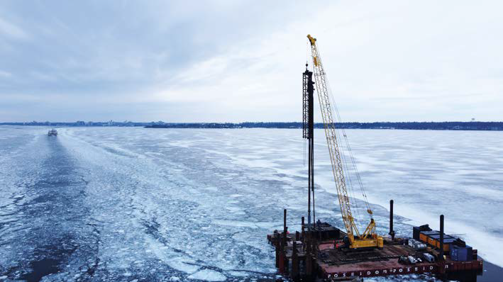 An image of frozen lake Ontario in winter, with a drilling barge at the front